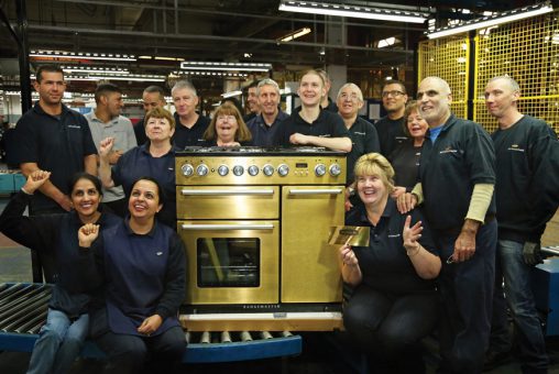 AGA staff celebrate the construction of this golden cooker. 