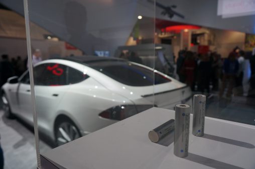 Panasonic is proud that this Tesla electric car (shown in the background) runs on Panasonic batteries.