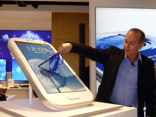 Tyler McGee cuts the Samsung Galaxy S Cake to open its Sydney retail store.