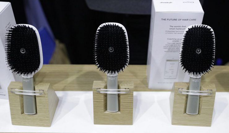 Hair Coach smart hairbrushes are displayed at the Withings booth during CES Unveiled before CES International, Tuesday, Jan. 3, 2017, in Las Vegas. The brush uses sensors to track hair damage and will, via a smart-phone app, offer recommendations and advice on hair care. (AP Photo/John Locher)